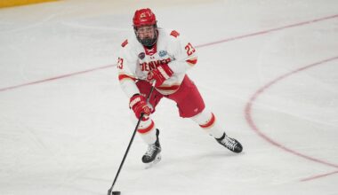 Apr 11, 2026; Las Vegas, Nevada, United States; Denver Pioneers defenseman Eric Pohlkamp (23) skates up the ice with the puck during the first period against the Wisconsin Badgers in the championship game of the NCAA men's ice hockey Frozen Four at T-Mobile Arena. Mandatory Credit: Lucas Peltier-Imagn Images