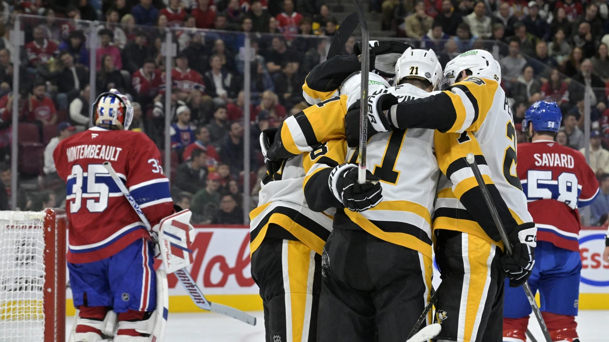 Pittsburgh Penguins forward Rickard Rakell (67) celebrates with teammates after scoring a goal against Montreal Canadiens goalie Sam Montembeault (35) during the first period at the Bell Centre.