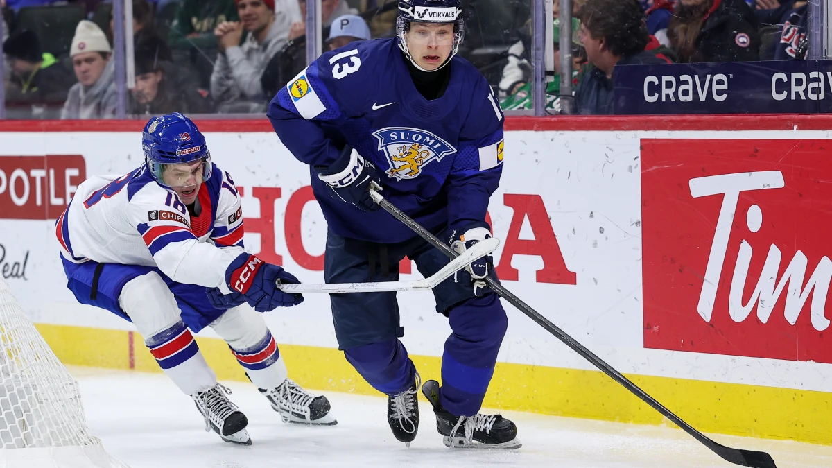 Finland defenseman Veeti Vaisanen (13) skates with the puck as United States forward L.J. Mooney (18) defends during the third period in the quarterfinals of the 2026 IIHF World Junior Championship at Grand Casino Arena.