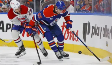 Edmonton Oilers forward Noah Philp (48) and Montreal Canadiens forward Juraj Slafkovsky (20) battle along the boards for a loose puck during the second period at Rogers Place.