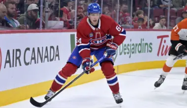 Montreal Canadiens defenseman David Reinbacher (64) plays the puck during the second period against the Philadelphia Flyers at the Bell Centre.