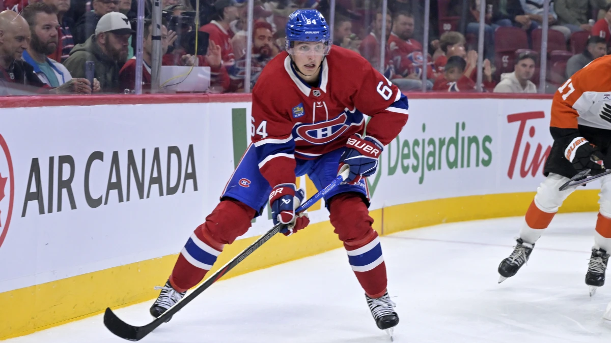 Montreal Canadiens defenseman David Reinbacher (64) plays the puck during the second period against the Philadelphia Flyers at the Bell Centre.