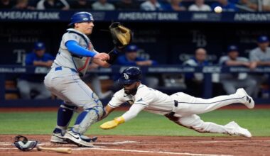 Tampa Bay Rays' Cedric Mullins, right, scores ahead of the throw to Toronto Blue Jays catcher Brandon Valenzuela on a bunt during the fourth inning of a baseball game Wednesday, Aug. 19, 2026, in St. Petersburg, Fla. (AP Photo/Chris O'Meara)