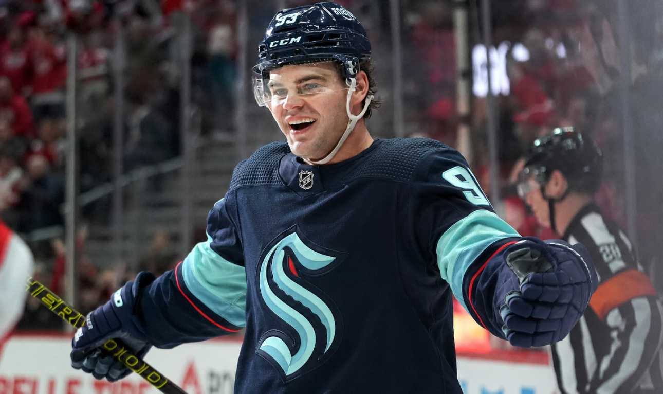 Concept image for Alex DeBrincat trade rumours showing a hockey player in a Seattle Kraken home jersey and helmet