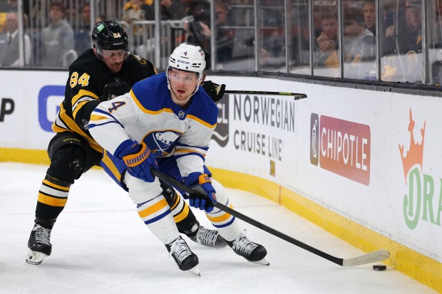 Sabres defenseman Bowen Byram shields the puck from the Bruins' Tanner Jeannot during Game 4 of a first-round playoff series April 26, 2026, in Boston. (Maddie Meyer/Getty)