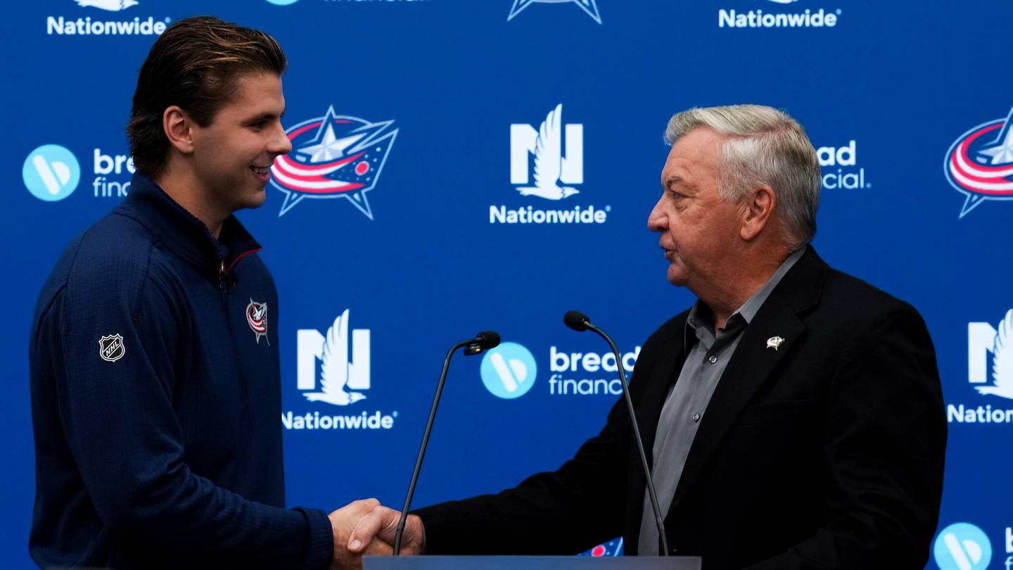 Sep 24, 2026; Columbus, Ohio, USA;  Columbus Blue Jackets’ Adam Fantilli, left, shakes hands with Columbus general manager and president of hockey operations Don Waddell, right, after signing a contract, before the game against the Pittsburgh Penguins at Nationwide Arena. Mandatory Credit: Aaron Doster-Imagn Images