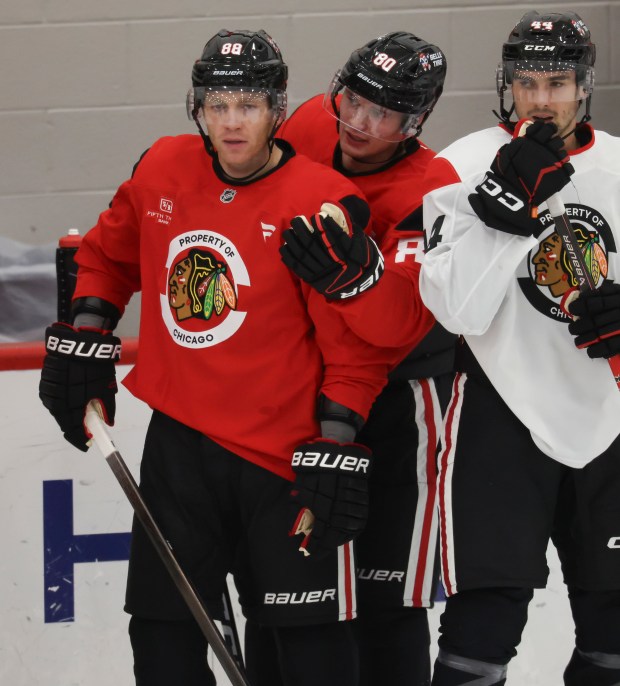 Patrick Kane (88) and Roman Kantserov (80) talk during practice Thursday, Sept. 17, 2026, during training camp at the Blackhawks Ice Center. (Brian Cassella/Chicago Tribune)
