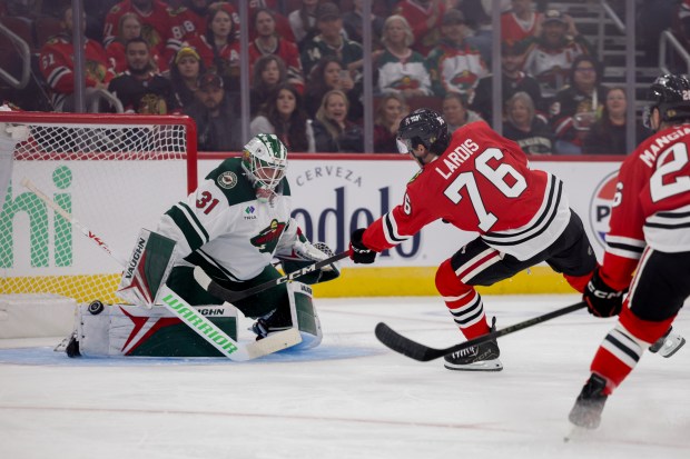 Blackhawks left wing Nick Lardis (76) scores past Wild goalie Calvin Pickard (31) during the first period of the Blackhawks preseason opener at the United Center Sept. 21, 2026 in Chicago. (Armando L. Sanchez/Chicago Tribune)