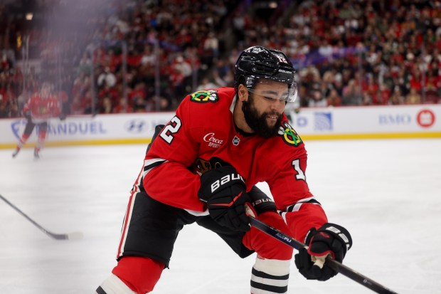 Blackhawks left wing Jordan Greenway (12) reaches for the puck during the second period of the Blackhawks preseason opener against the Wild at the United Center Sept. 21, 2026 in Chicago. (Armando L. Sanchez/Chicago Tribune)