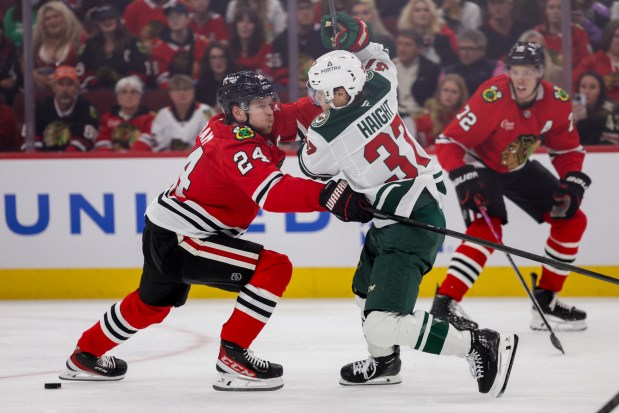 Blackhawks defenseman Bowen Byram (24) guards Wild center Hunter Haight (37) during the second period of the Blackhawks preseason opener against the Wild at the United Center Sept. 21, 2026 in Chicago. (Armando L. Sanchez/Chicago Tribune)