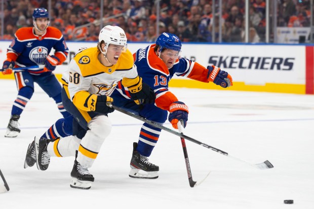 Mattias Janmark #13 of the Edmonton Oilers defends against Zachary L'Heureux #68 of the Nashville Predators during the first period at Rogers Place on November 14, 2024 in Edmonton, Canada. (Photo by Codie McLachlan/Getty Images)