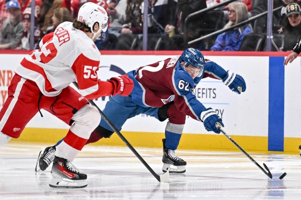Artturi Lehkonen (62) of the Colorado Avalanche reaches for the puck as Moritz Seider (53) of the Detroit Red Wings defends during the third period of the Red Wings' 2-0 win at Ball Arena on Tuesday, February 2, 2026. (Photo by AAron Ontiveroz/The Denver Post)