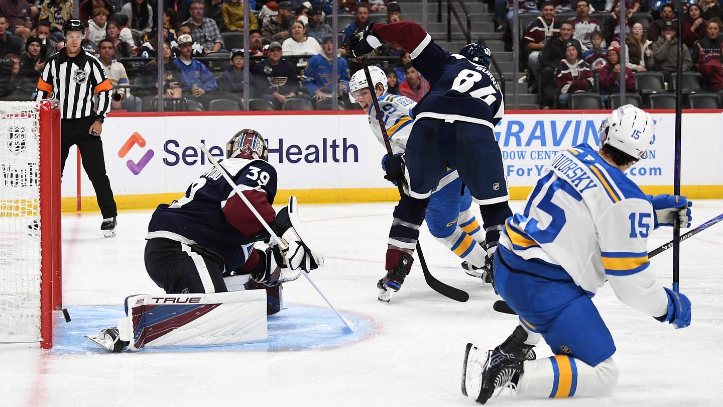 Oct 3, 2026; Denver, Colorado, USA; St. Louis Blues right winger Dalibor Dvorsky (15) scores past Colorado Avalanche goalie Mackenzie Blackwood (39) during the third period at Ball Arena. Mandatory Credit: Christopher Hanewinckel-Imagn Images