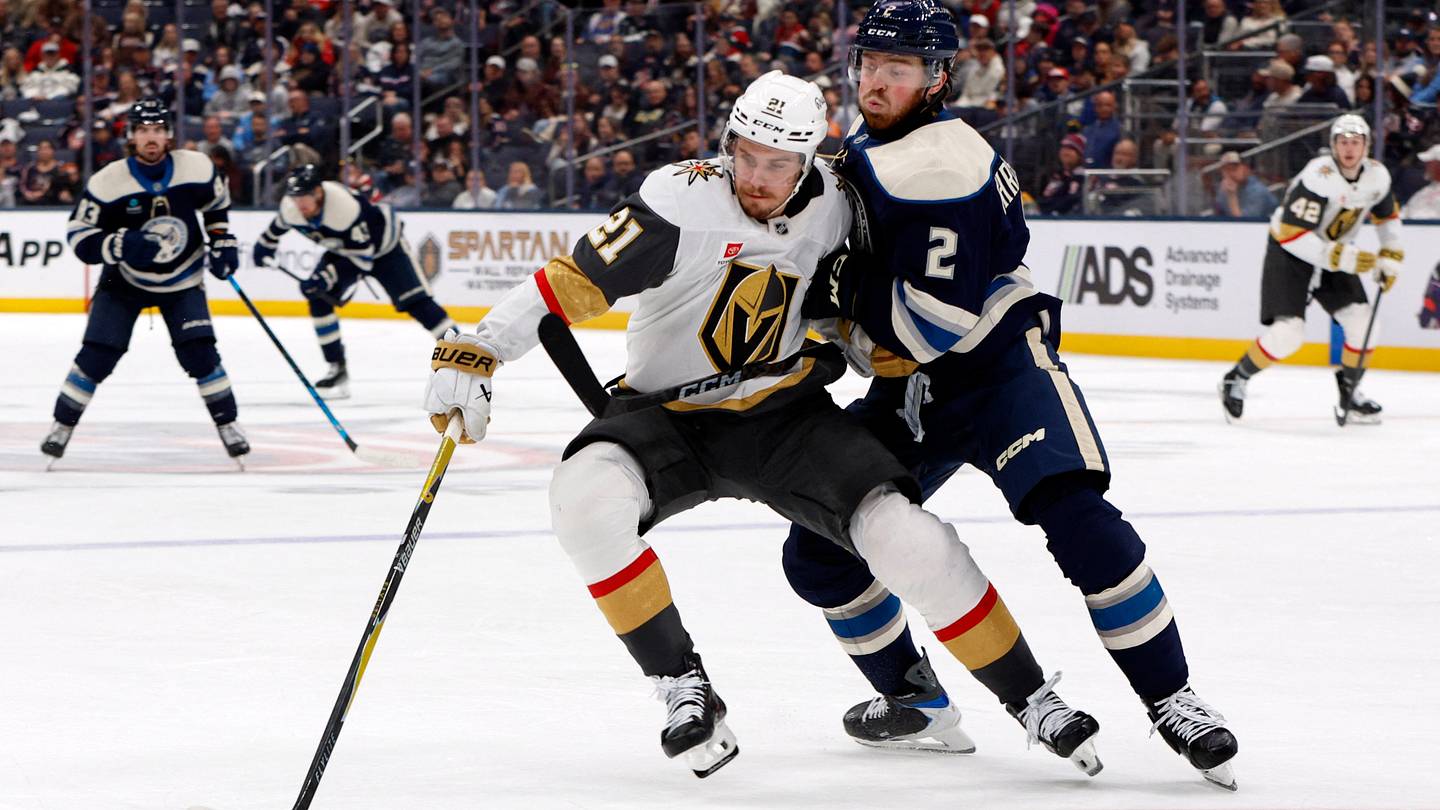 Columbus Blue Jackets defenseman Jake Christiansen (2) checks Vegas Golden Knights center Brett Howden (21) during the third period at Nationwide Arena.  Mandatory Credit: Russell LaBounty-Imagn Images