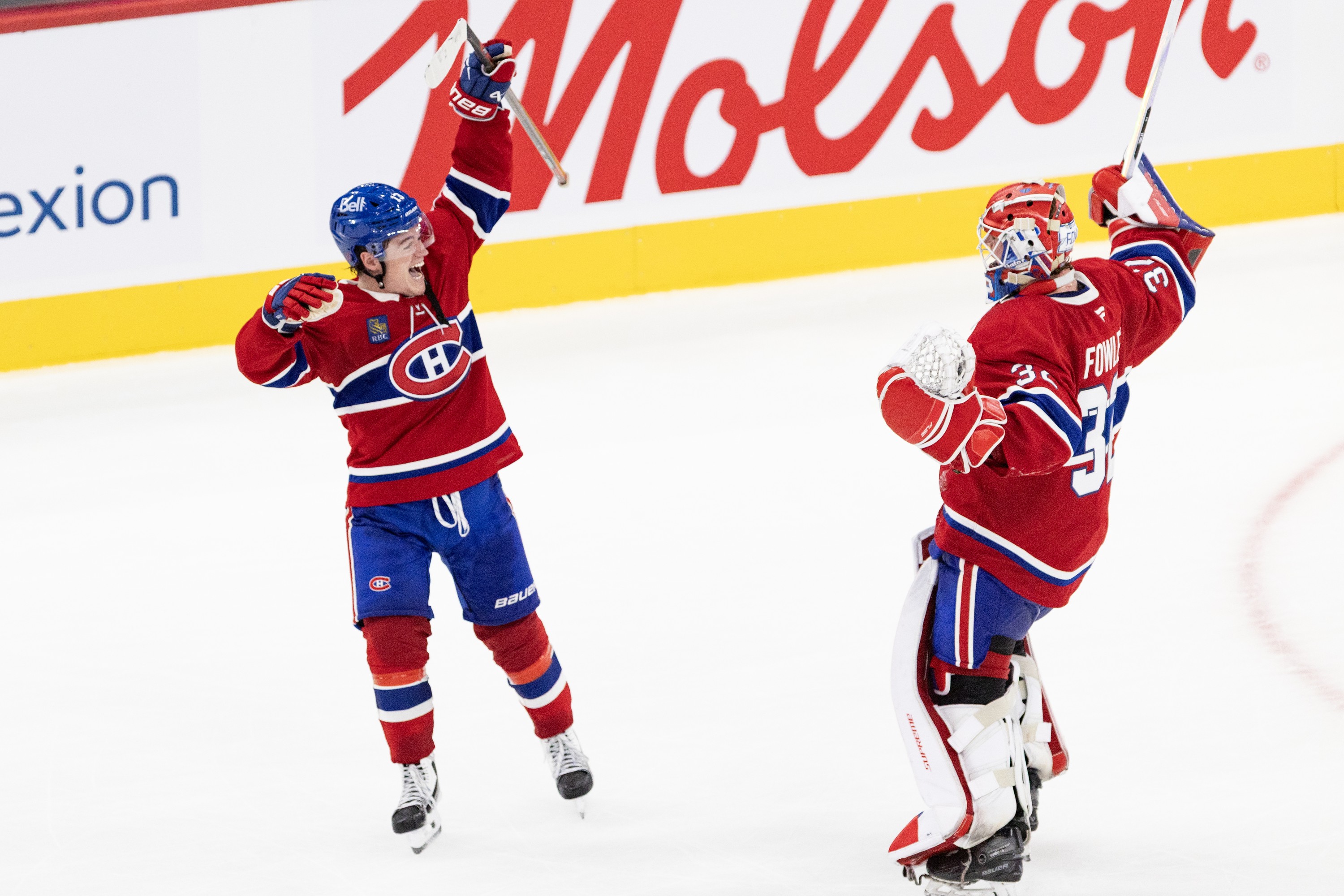 Winger Cole Caufield and Jacob Fowler celebrate the Canadiens' shootout victory over the Detroit Red Wings in Montreal on Saturday.
