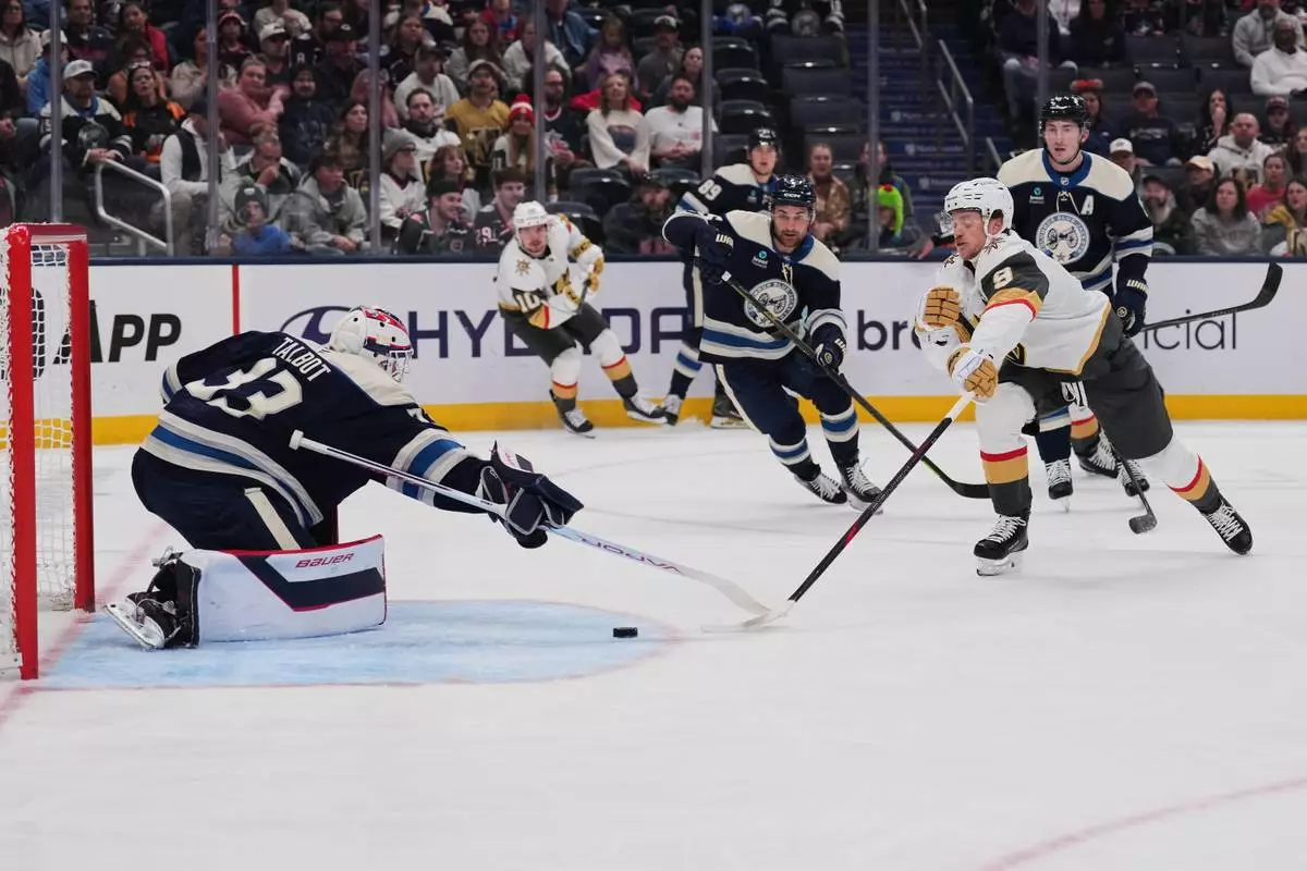 Vegas Golden Knights center Jack Eichel (9) attempts a shot as Columbus Blue Jackets goaltender Cam Talbot (33) defends during the first period of an NHL hockey game Saturday, Oct. 24, 2026, in Columbus, Ohio. (AP Photo/Joshua A. Bickel)