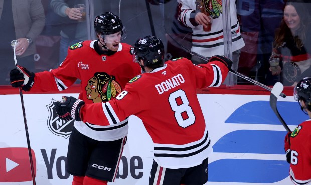 Chicago Blackhawks defenseman Sam Rinzel (6) and center Ryan Donato (8) celebrate after a goal by Rinzel in the second period of the home opener against the St. Louis Blues at the United Center in Chicago on Oct. 6, 2026. (Chris Sweda/Chicago Tribune)