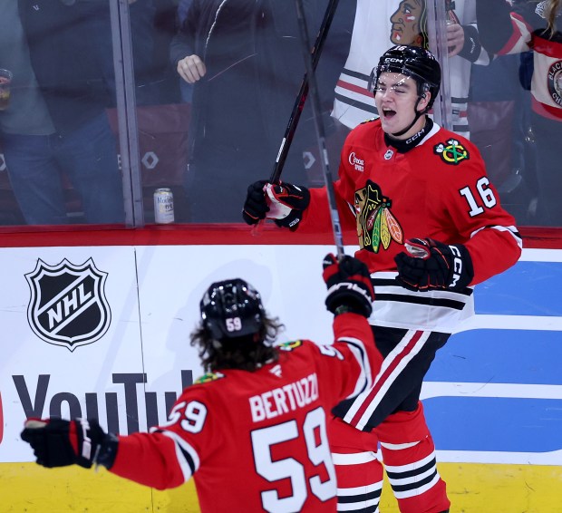 Chicago Blackhawks center Anton Frondell (16) celebrates with teammate Tyler Bertuzzi (59) after a goal by Frondell in the second period of the home opener against the St. Louis Blues at the United Center in Chicago on Oct. 6, 2026. (Chris Sweda/Chicago Tribune)
