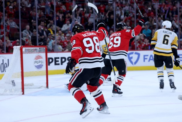 Chicago Blackhawks center Connor Bedard (98) celebrates after his assist to set up a goal by right wing Roman Kantserov in the first period of a game against the Pittsburgh Penguins at the United Center in Chicago on Oct. 13, 2026. (Chris Sweda/Chicago Tribune)