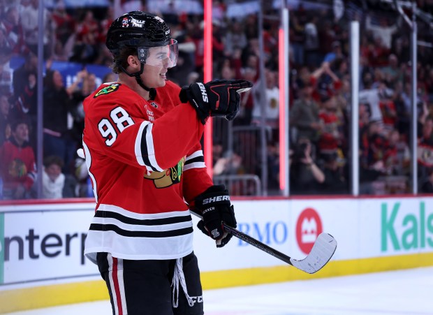 Chicago Blackhawks center Connor Bedard (98) celebrates after his assist to set up a goal by right wing Roman Kantserov in the first period of a game against the Pittsburgh Penguins at the United Center in Chicago on Oct. 13, 2026. (Chris Sweda/Chicago Tribune)