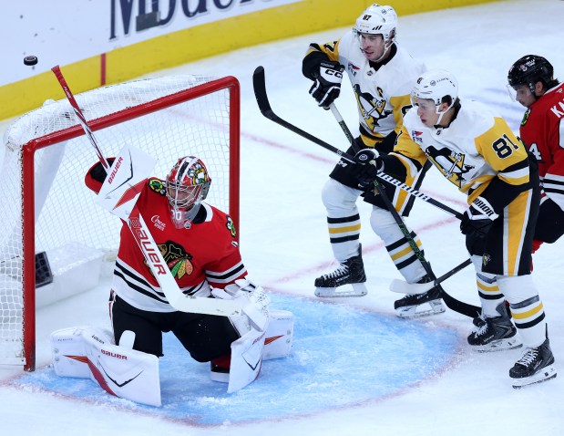 Chicago Blackhawks goaltender Spencer Knight (30) blocks away a puck on a shot attempt by the Pittsburgh Penguins in the second period of a game at the United Center in Chicago on Oct. 13, 2026. (Chris Sweda/Chicago Tribune)