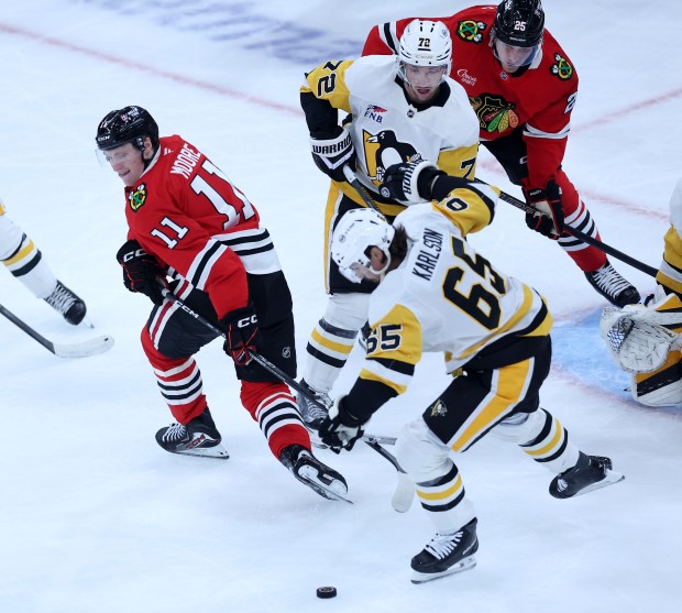 Chicago Blackhawks center Oliver Moore (11) tries to locate the puck in the second period of a game against the Pittsburgh Penguins at the United Center in Chicago on Oct. 13, 2026. (Chris Sweda/Chicago Tribune)