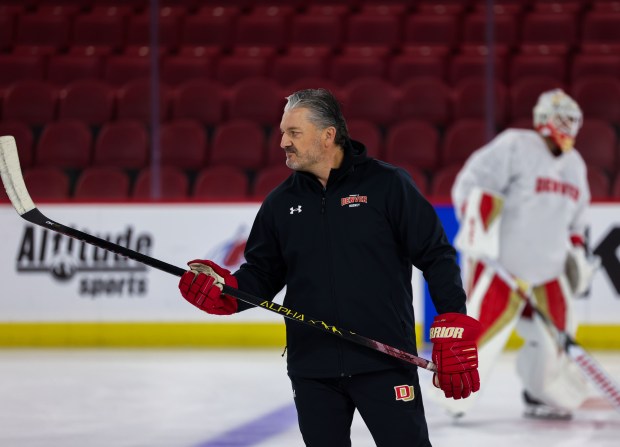 Tavis MacMillan has won four national championships as an assistant coach with the Pioneers and was promoted to general manager and assistant coach before the season. (Courtesy DU Athletics)