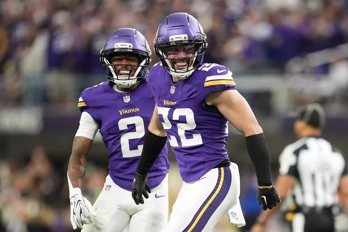 Minnesota Vikings safety Harrison Smith (22) celebrates with cornerback Isaiah Rodgers (2) after intercepting a pass against the Indianapolis Colts during the second half of an NFL football game in Minneapolis, Sunday, Oct. 25, 2026. (AP Photo/Ellen Schmidt)