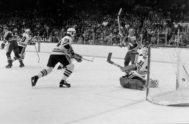 Edmonton Oilers phenom Wayne Gretzky (99), second from right, was given an assist on a powerplay goal made by Keith Lowe (4) against the Chicago Blackhawks on Oct. 10, 1979, at Chicago Stadium. It was Gretzky's first NHL game and also the Oilers' NHL debut. The Hawks won 4-2. (Walter Neal/Chicago Tribune)