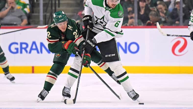 Minnesota Wild forward Danila Yurov battles for the puck against the Dallas Stars