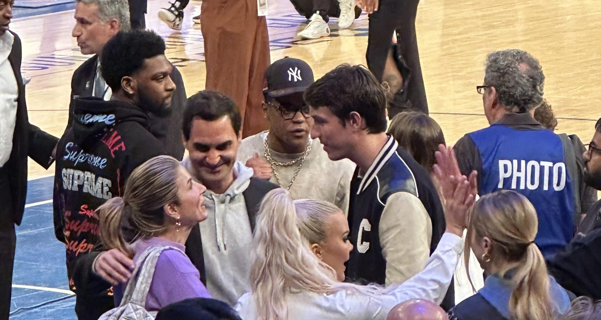 Can someone help my boy identify the dude with the varsity jacket next to federer? Swear hes a celebrity but not sure who lol