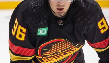 Canucks wearing matte black helmets with their retro jerseys