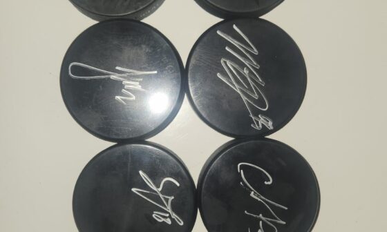 My signed puck collection! Details in text.