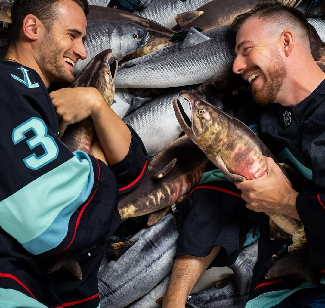 [Kraken] players posed for photos on a pile of plush salmon during media day