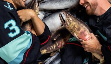 [Kraken] players posed for photos on a pile of plush salmon during media day
