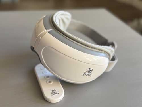 A white eye mask with a remote control, both featuring the logo "Bob and Bird."
