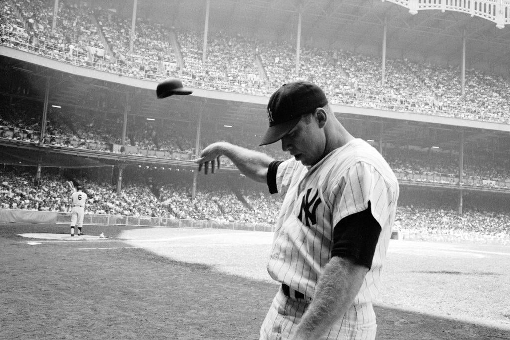 33-year-old Mickey Mantle—his electrifying talents blunted by injuries, age and years of alcohol abuse—tosses his helmet away in disgust after a weak at-bat at Yankee Stadium, June 1965.