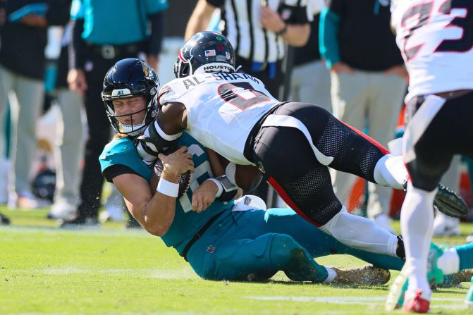 Jacksonville Jaguars quarterback Trevor Lawrence is hit by Houston Texans linebacker Azeez Al-Shaair during their game on December 1 in Jacksonville, Florida. Lawrence was <a href=