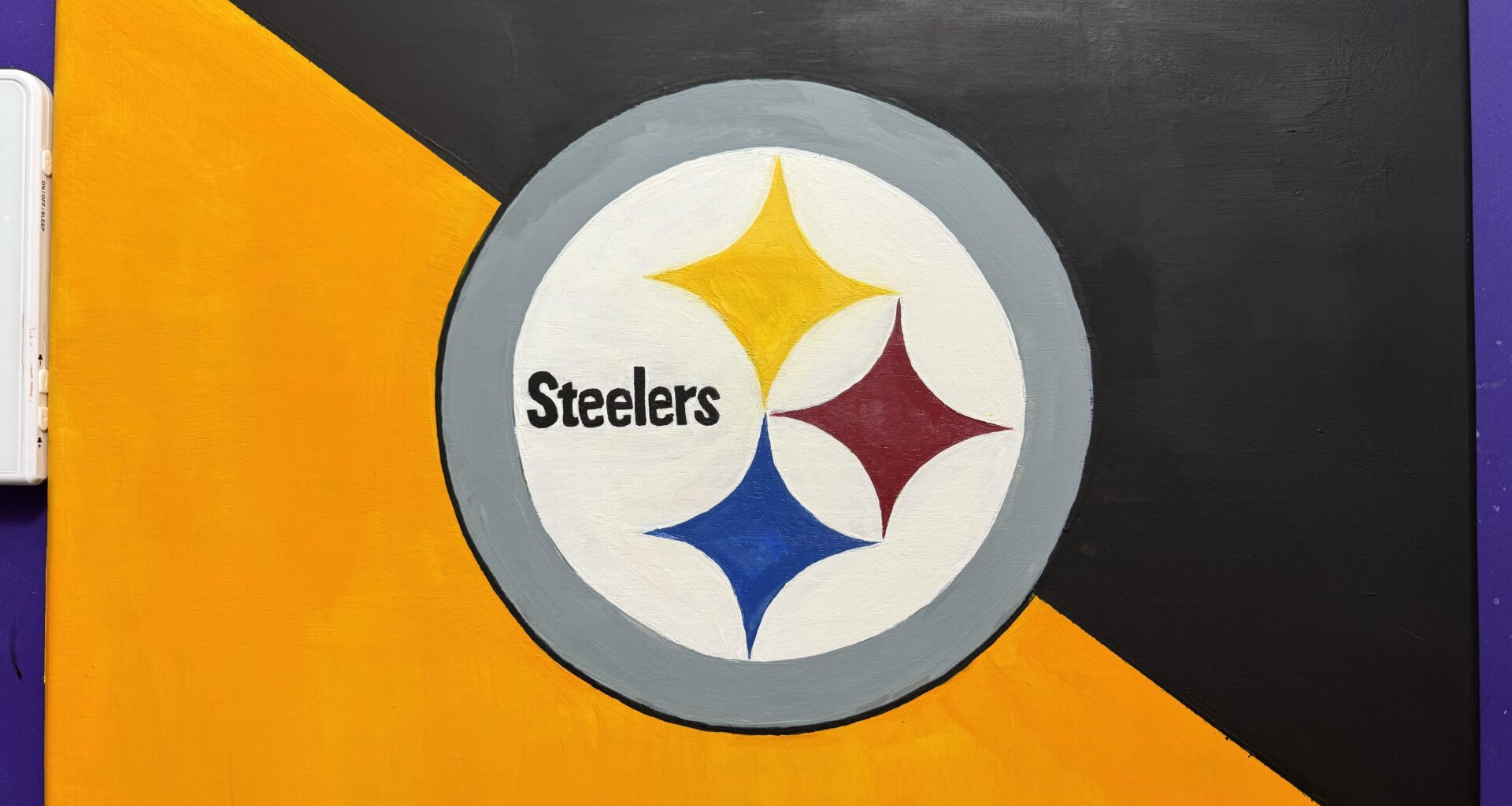 I know the color looks orange but I swear it’s different in another light. Anyways this is my freehanded painting of the logo