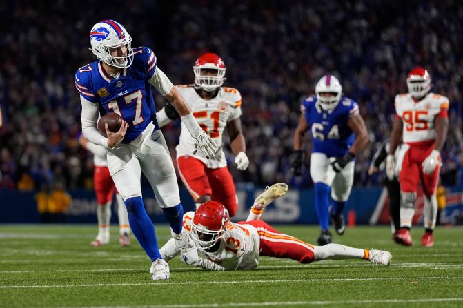 Buffalo Bills quarterback Josh Allen slips past Kansas City Chiefs cornerback Nazeeh Johnson to score on a 26-yard run near the end of the game in Orchard Park, New York, on Sunday, November 17. <a href=