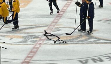 [Daugherty] Assistant coaches Todd Richards and Derek Mackenzie attempt to decipher the puck design someone made at center ice.