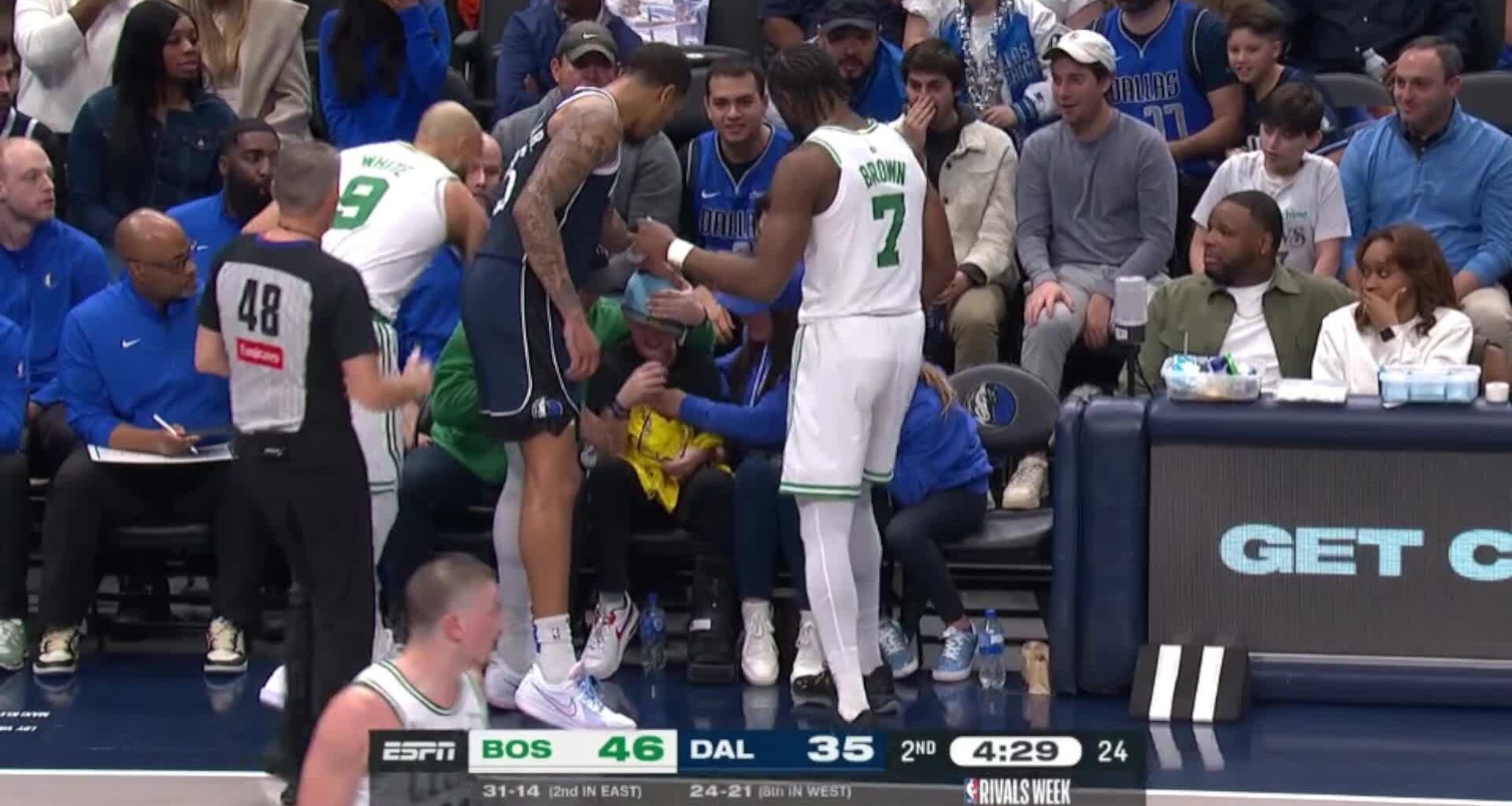 A young Mavs fan sitting courtside gets beaned by a Kyrie Irving pass