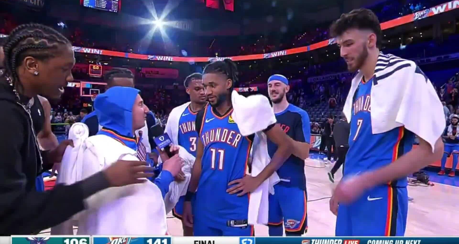 The Oklahoma City Thunder players dress up Nick Gallo with OKC gear during the postgame interview on the court.