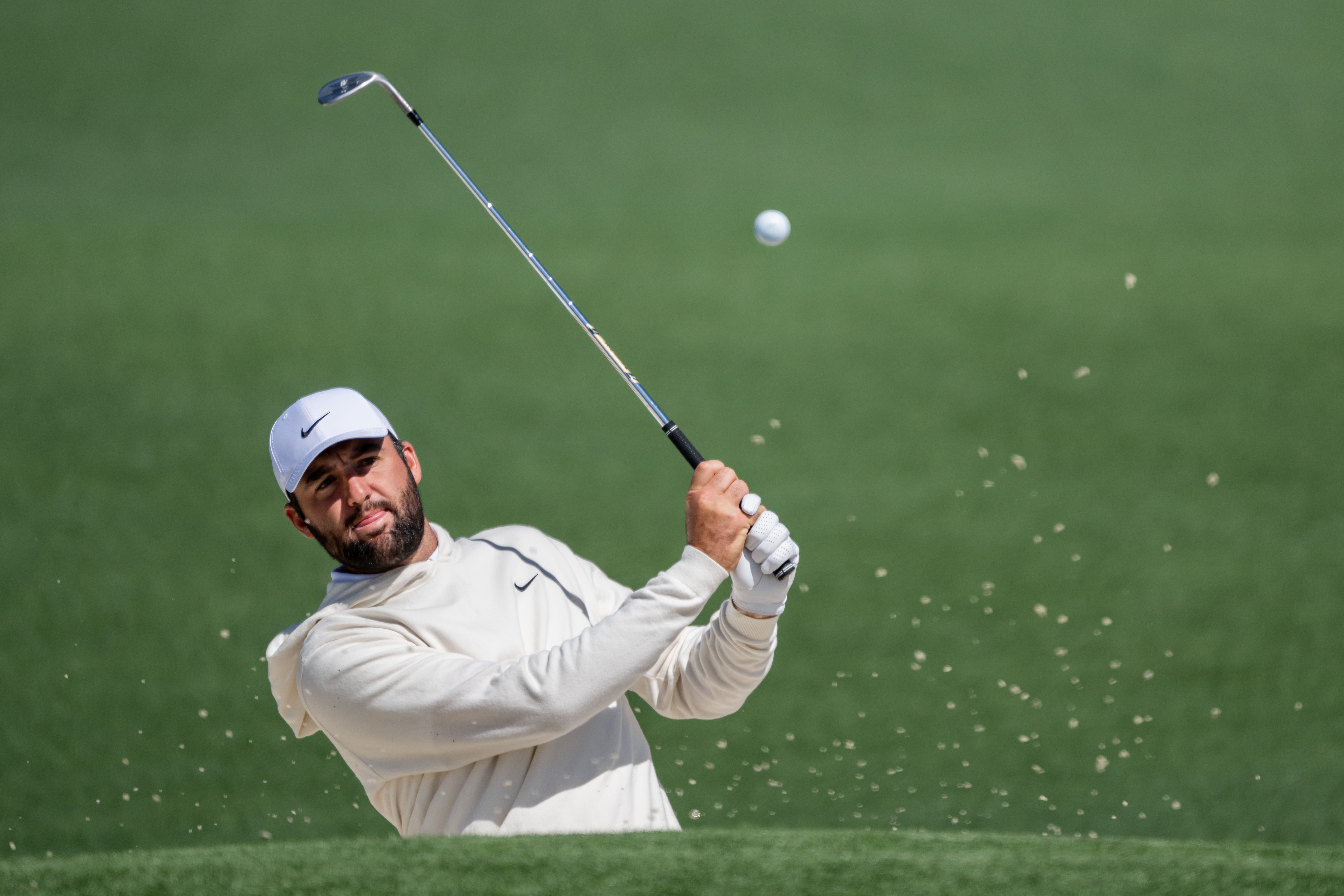 Scottie Scheffler golfing at the Masters Tournament.