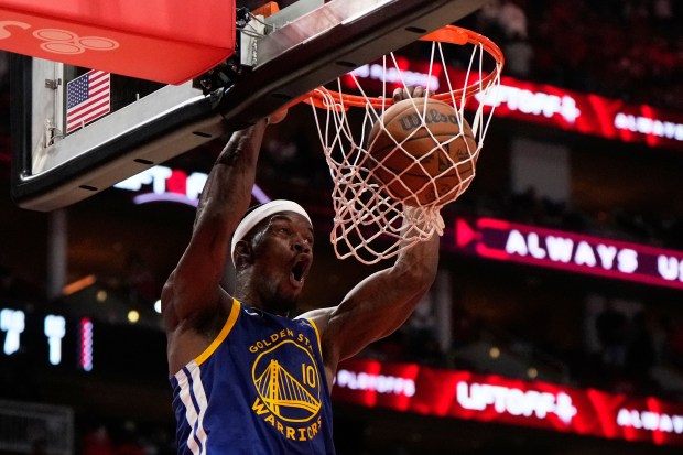 Golden State Warriors forward Jimmy Butler III (10) dunks during the second half of Game 1 of an NBA basketball first-round playoff series against the Houston Rockets in Houston, Sunday, April 20, 2025. (AP Photo/Ashley Landis)