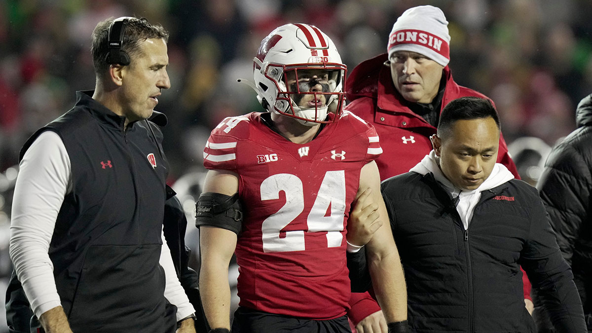 Wisconsin head coach Luke Fickell, left, helps safety Hunter Wohler (24) get off the field after being injured during the fourth quarter of their game Saturday, November 16, 2024 at Camp Randall Stadium in Madison, Wisconsin. Oregon beat Wisconsin 16-13.
