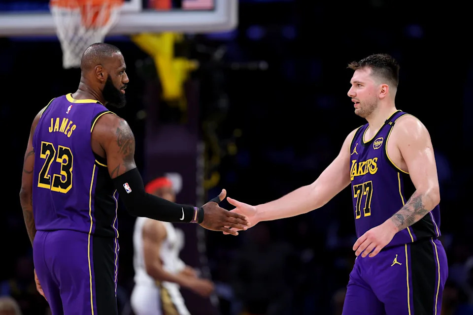 LOS ANGELES, CALIFORNIA - APRIL 04: LeBron James #23 and Luka Doncic #77 of the Los Angeles Lakers shake hands against the New Orleans Pelicans during the second quarter at Crypto.com Arena on April 04, 2025 in Los Angeles, California. NOTE TO USER: User expressly acknowledges and agrees that, by downloading and or using this photograph, user is consenting to the terms and conditions of the Getty Images License Agreement. (Photo by Luke Hales/Getty Images)