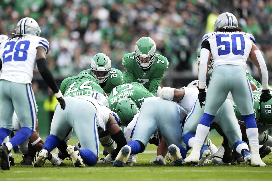 The tush push involves the quarterback moving forwards a few yards behind the offensive line, with other members of the team pushing from behind.