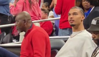 Hakeem Olajuwon and Victor Wembanyama at the NCAA Finals stands.