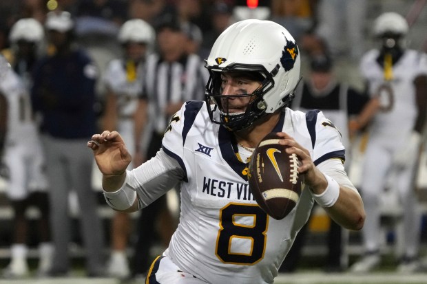West Virginia quarterback Nicco Marchiol (8) against Arizona in the first half during an NCAA college football game, Saturday, Oct. 26, 2024, in Tucson, Ariz. (AP Photo/Rick Scuteri)